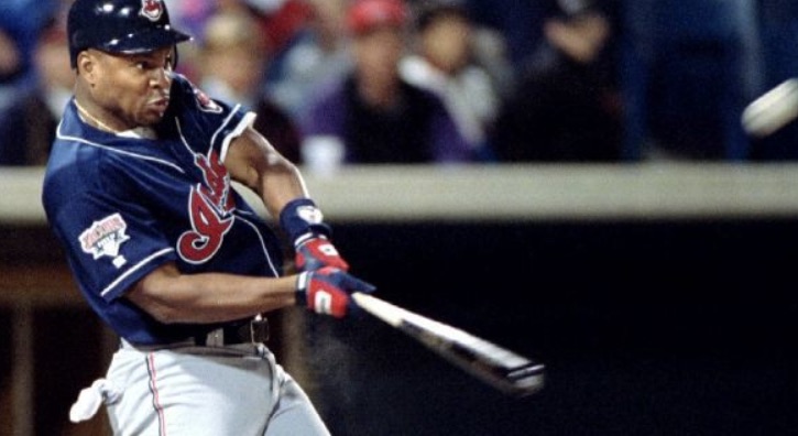 Albert Belle, while with the Cleveland Indians (Guardians), swings for a hit.